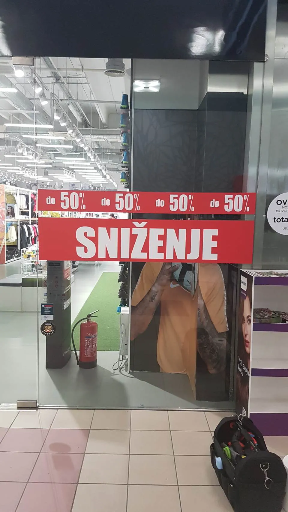 Sale stickers on a shop window and entrance glass